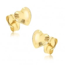 Glänzende goldene Ohrringe - unregelmäßige Herzen mit Strahlen