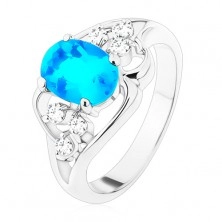 Silberfarbener Ring, großer blauer ovaler Zirkon, asymmetrische Linien